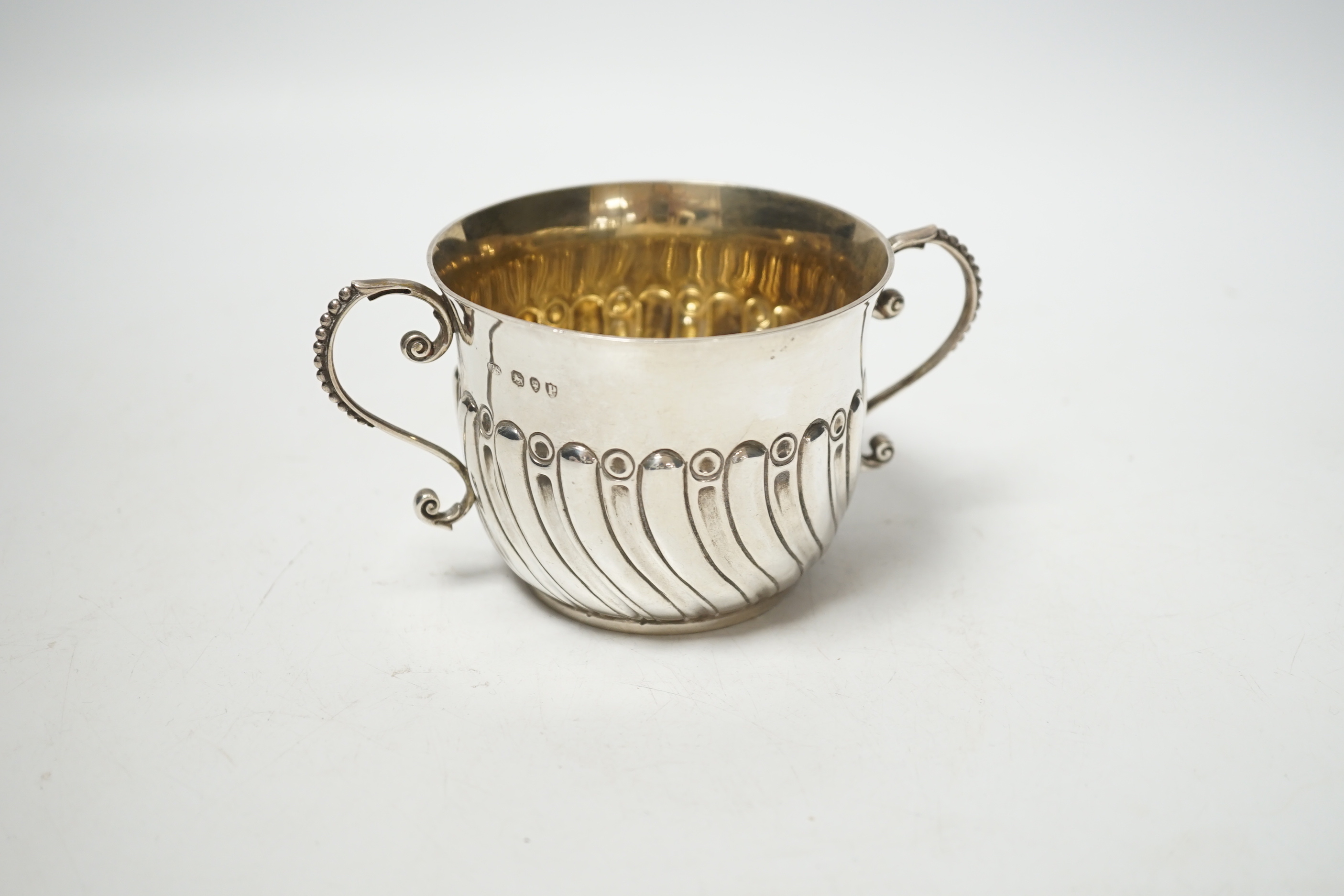 A late Victorian embossed silver porringer, Robert Stebbings, London, 1890, height 7cm, 4.9oz.